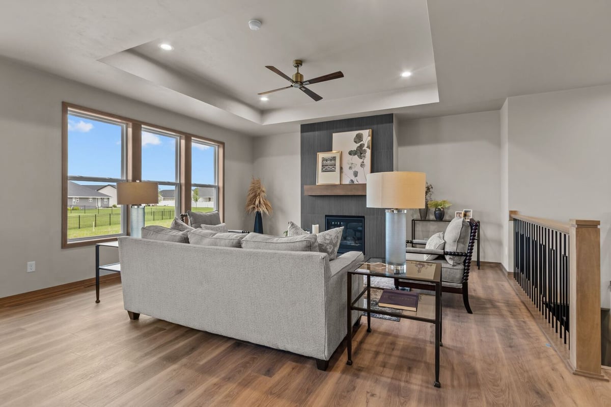 Contemporary living room with fireplace and tray ceiling in a Northern Wisconsin home