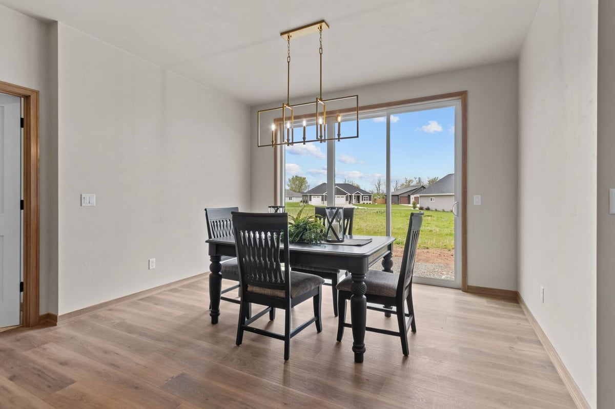 Dining space with sliding glass door and natural light in a Northern Wisconsin home