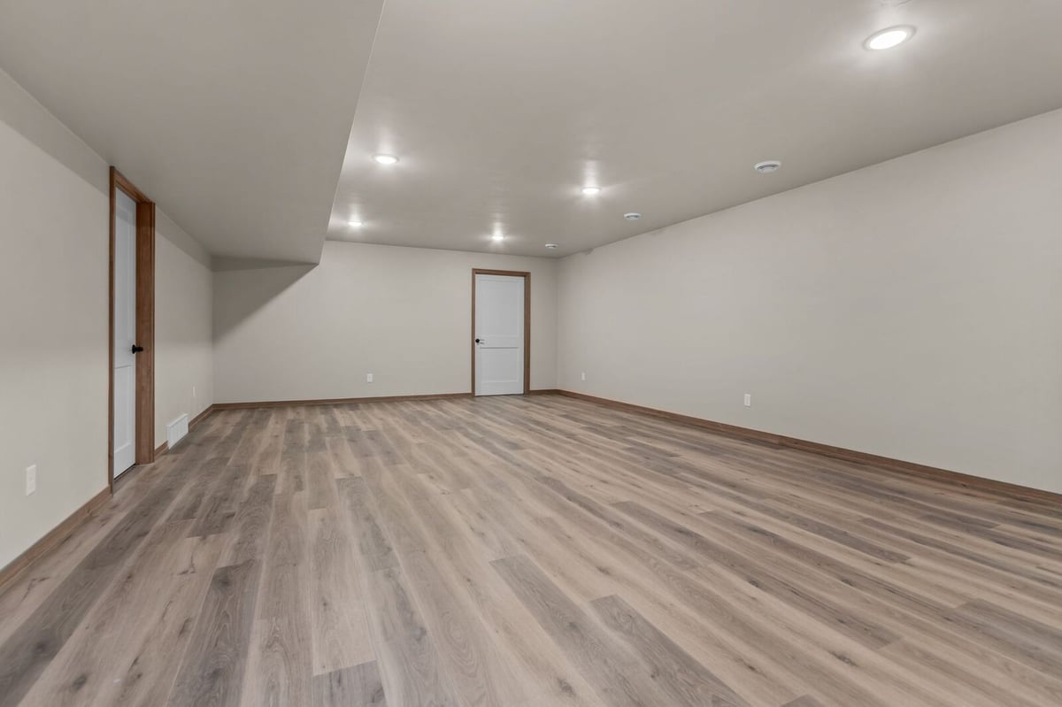 Expansive finished lower level with recessed lighting in a Northern Wisconsin home
