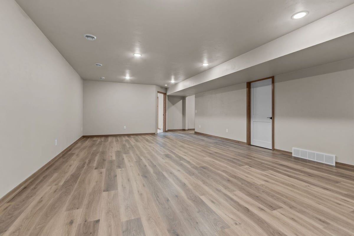 Finished lower-level living space with vinyl flooring in a Northern Wisconsin home