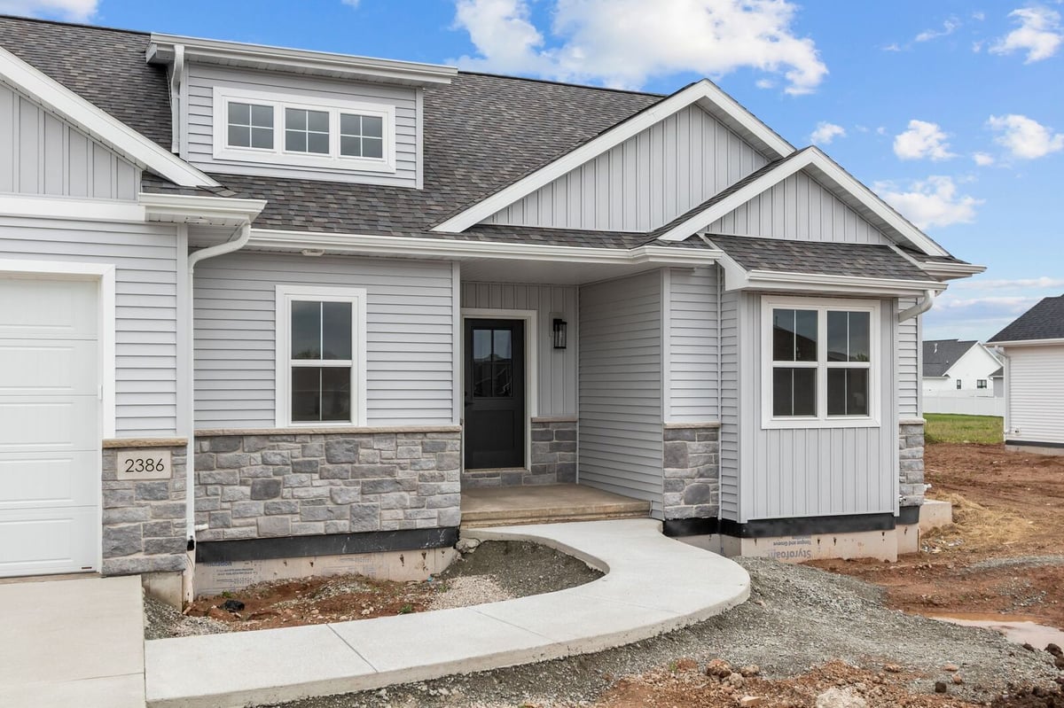 Front exterior with covered porch and stone detailing on a Northern Wisconsin home