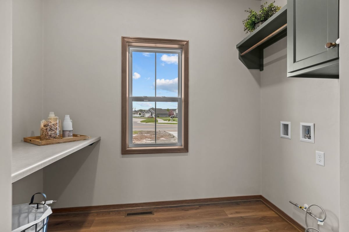Laundry room with utility hookups and window in a Northern Wisconsin home