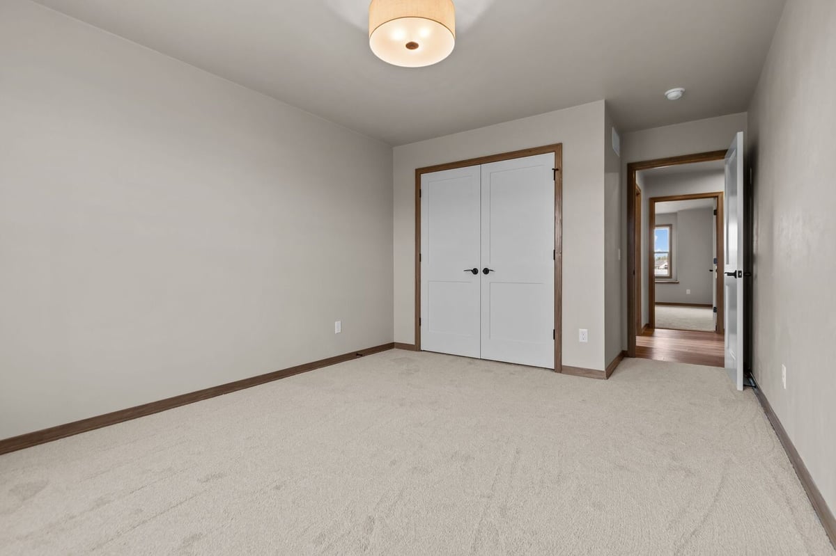 Minimalist bedroom with white closet doors in a Northern Wisconsin home