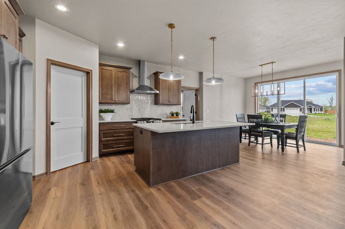 Modern kitchen with large island and dining area in a Northern Wisconsin open-concept home