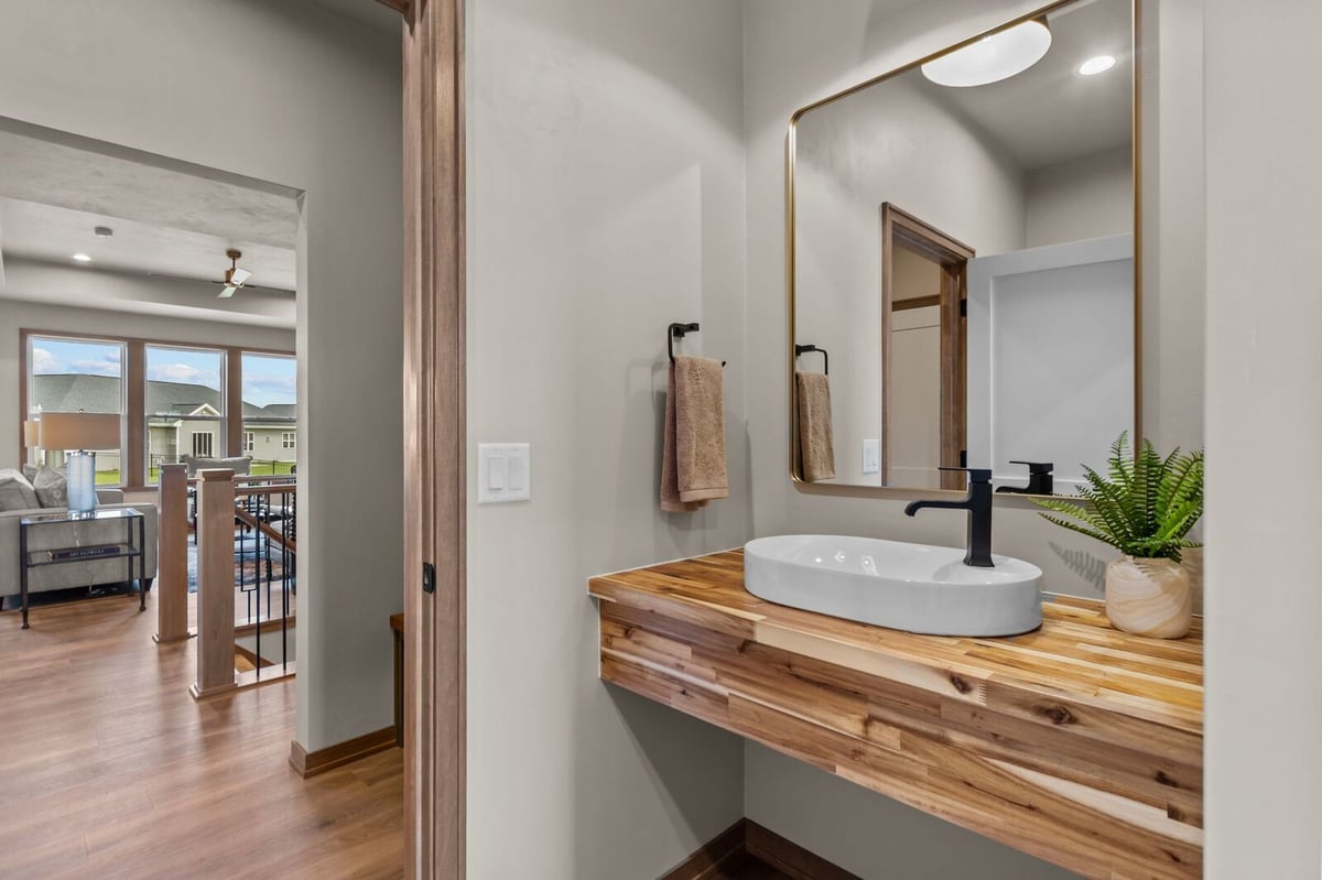 Modern vanity with vessel sink and wood countertop in a Northern Wisconsin home