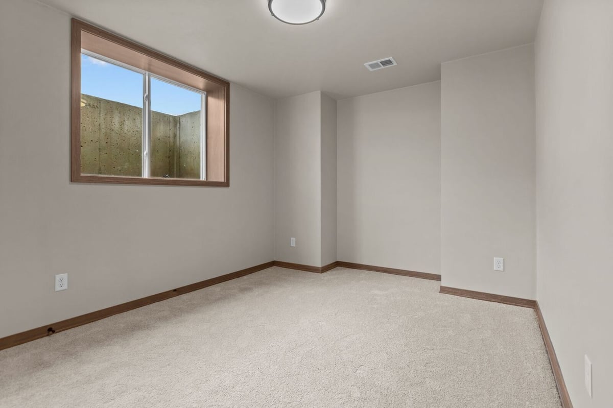 Northern Wisconsin home bedroom with carpet and a large window