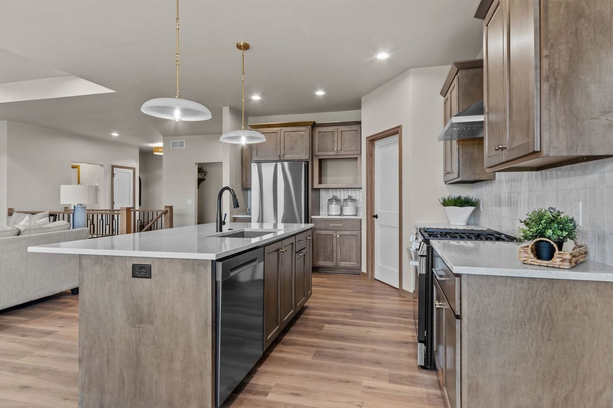 Northern Wisconsin kitchen with oversized island, pendant lighting, and open living space