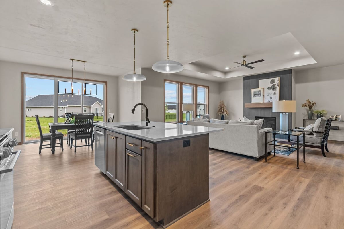 Open-concept kitchen and living room with large windows in a Northern Wisconsin home