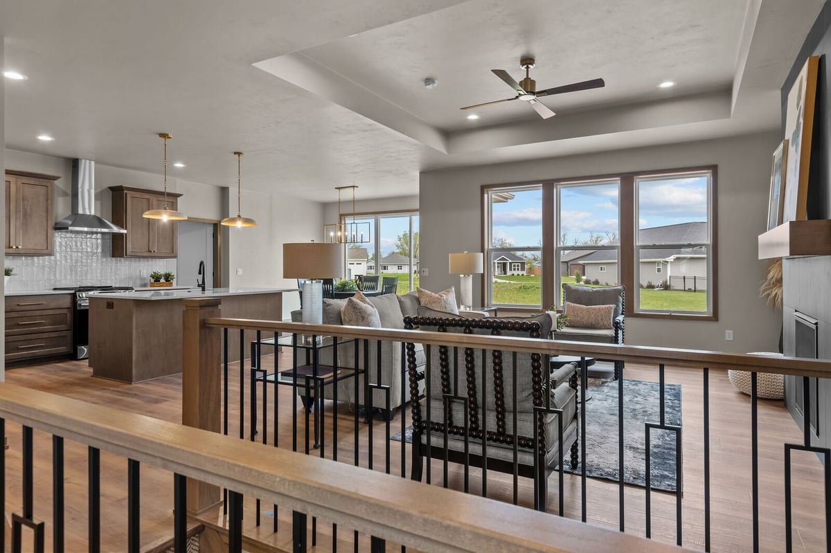 Open-concept living room and kitchen with large windows in a Northern Wisconsin home