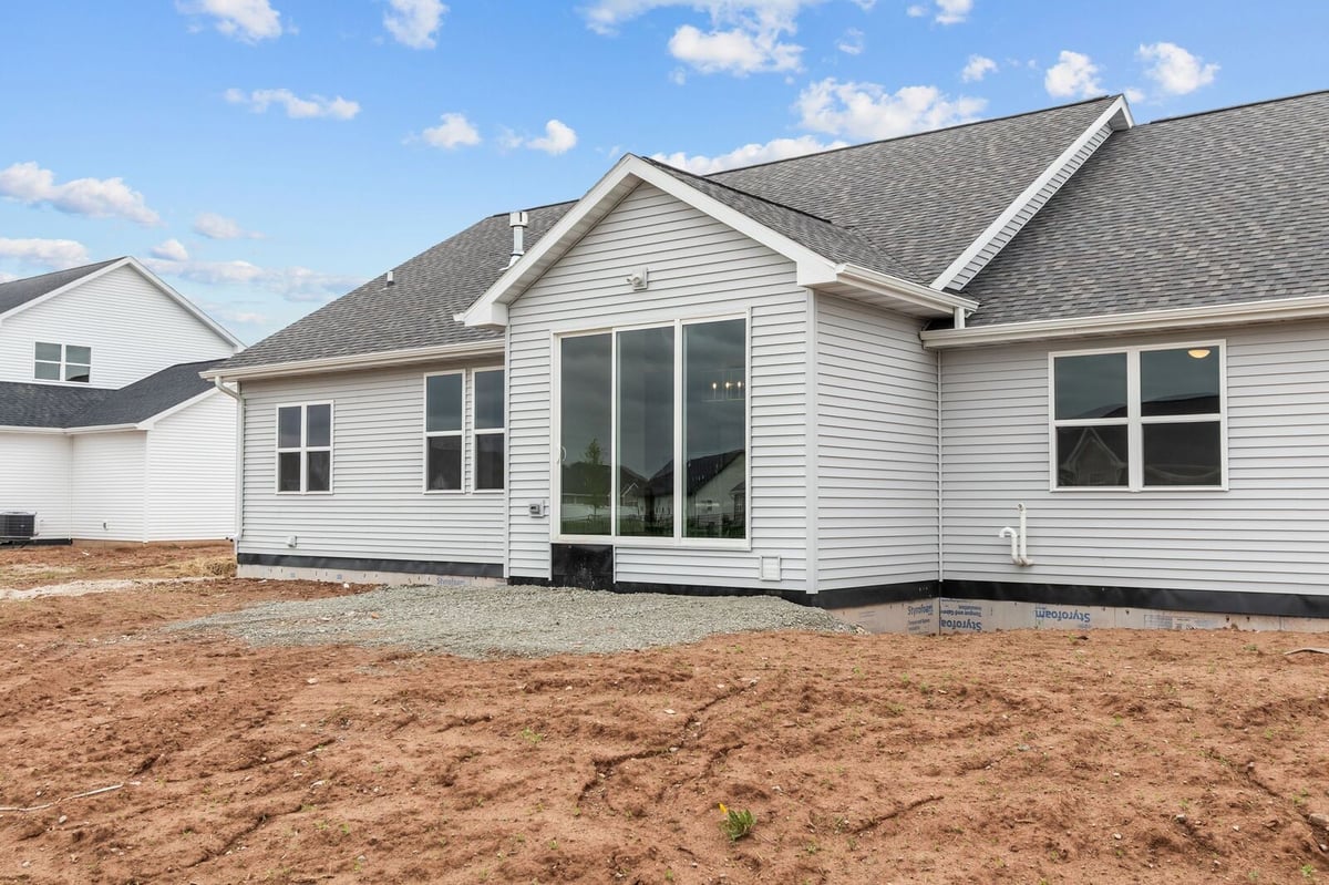 Rear view of new construction home with large windows in Northern Wisconsin