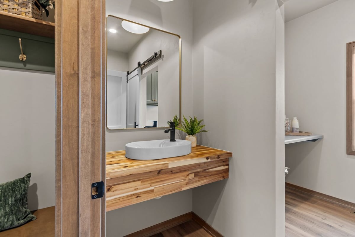 Rustic powder room with vessel sink and wood vanity in a Northern Wisconsin home