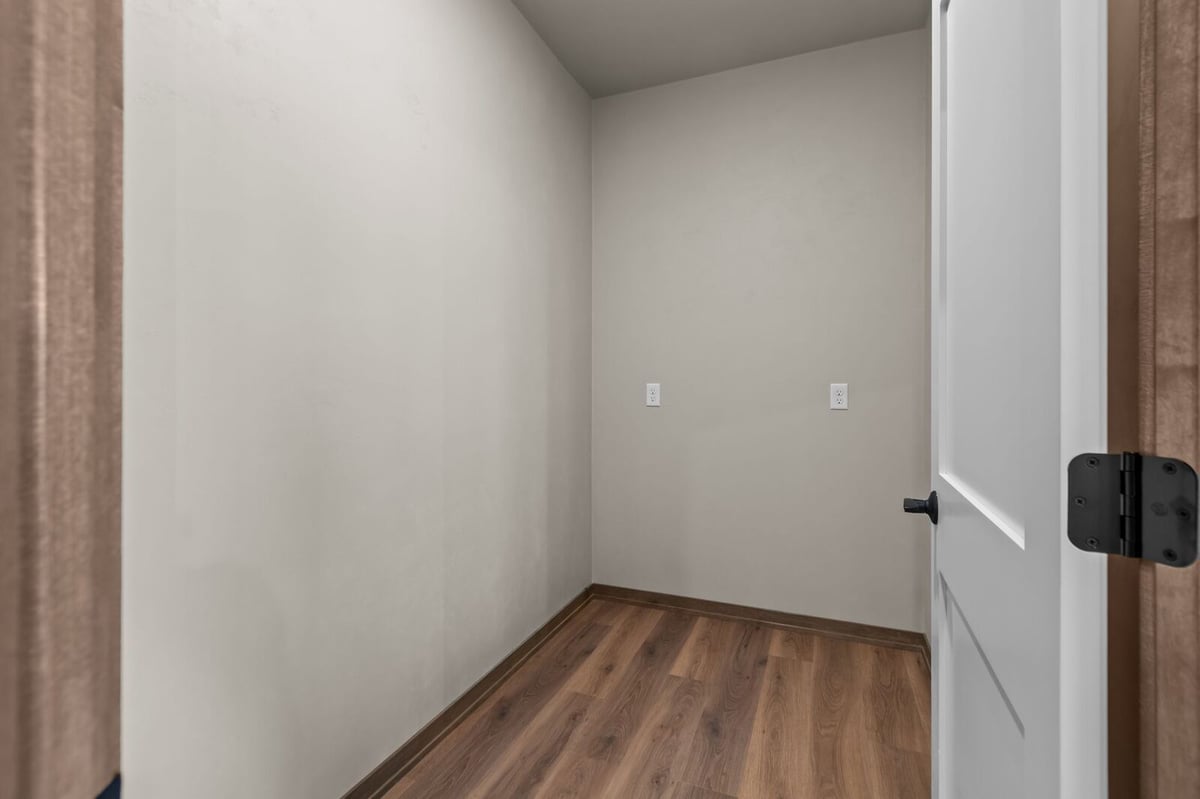 Small flex room with wood-look flooring in a Northern Wisconsin lower level