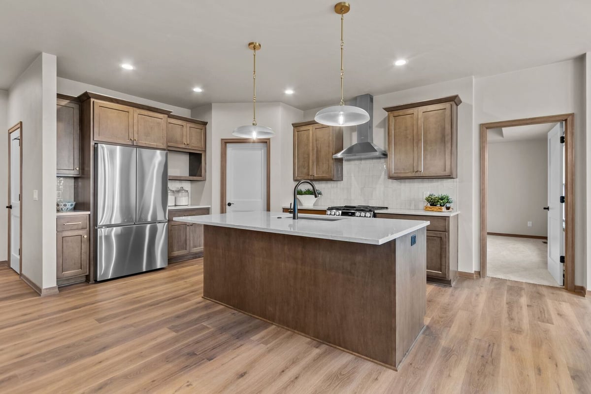 Spacious kitchen with large island and wood flooring in a Northern Wisconsin home