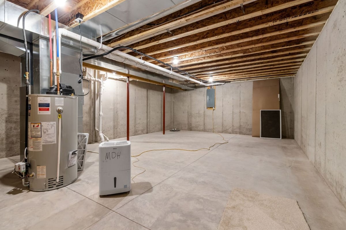 Spacious unfinished basement with utility area in a Northern Wisconsin home