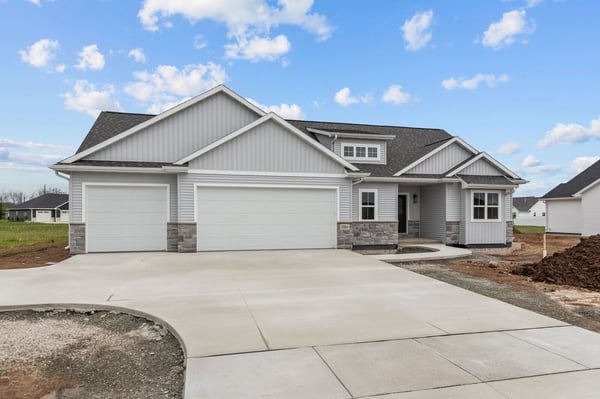 Wide view of new construction home with three-car garage in Northern Wisconsin