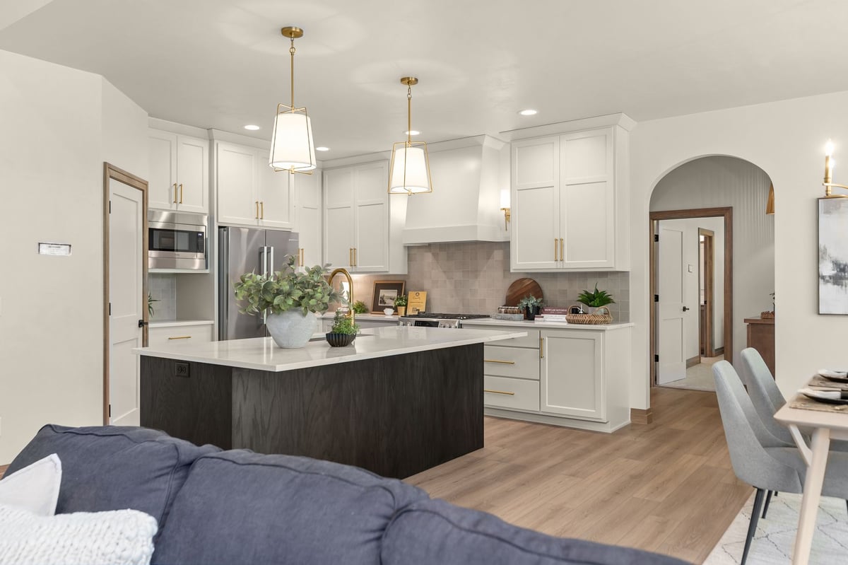 Open-concept kitchen with white cabinetry and dark wood island in a Northeast Wisconsin home