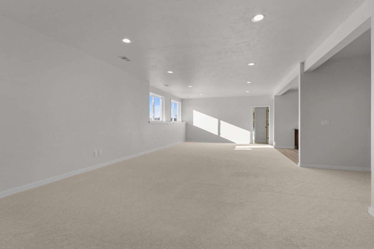 Appleton, WI large finished basement with carpet, recessed lighting, egress windows, and open layout
