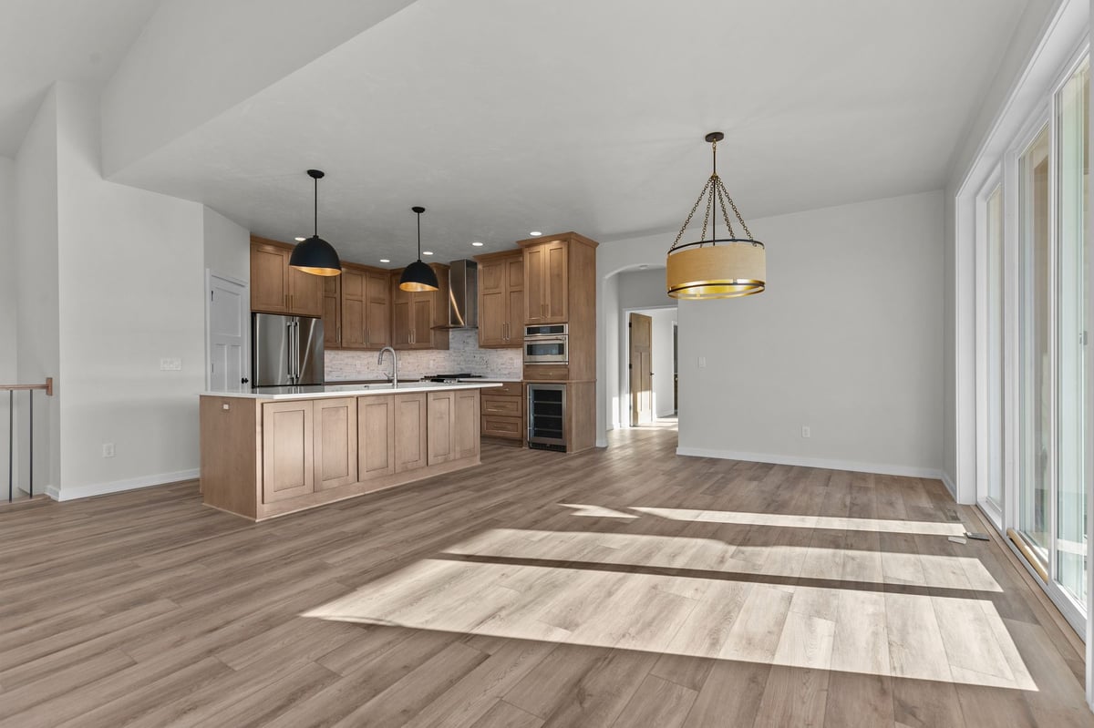 Appleton, WI open concept kitchen and dining area with large island, pendant lighting, and bright natural light