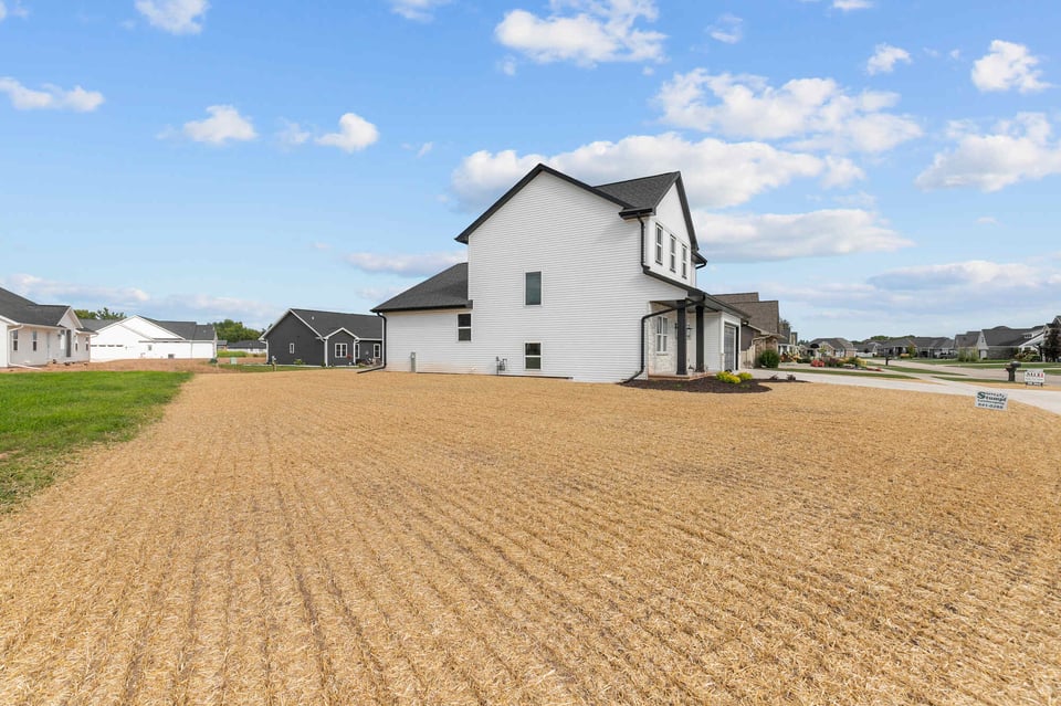 Two-story white custom home in Kaukauna, WI built by Midwest Design Homes on corner lot