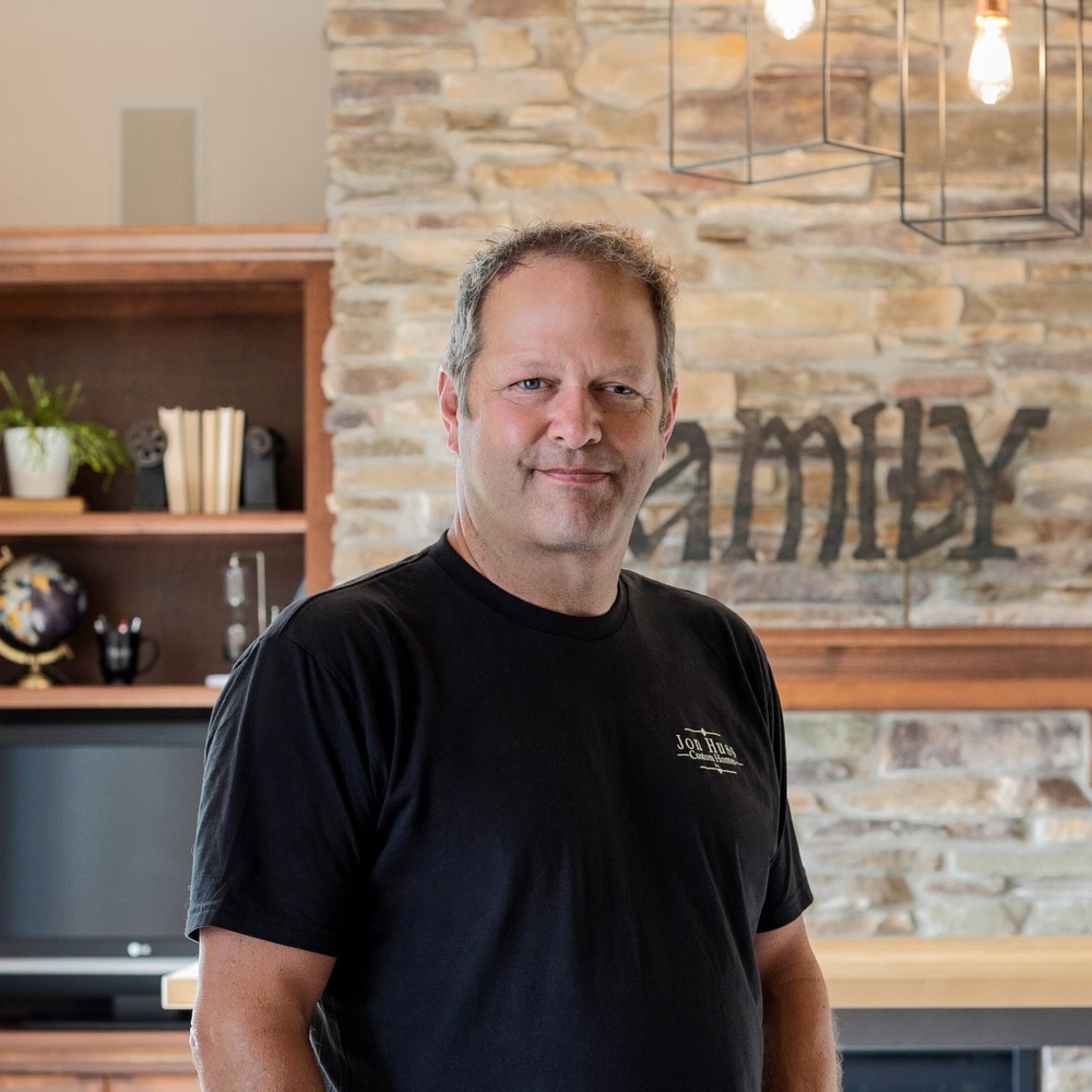 Midwest Design Homes co-owner stands in Ellington, WI custom home interior