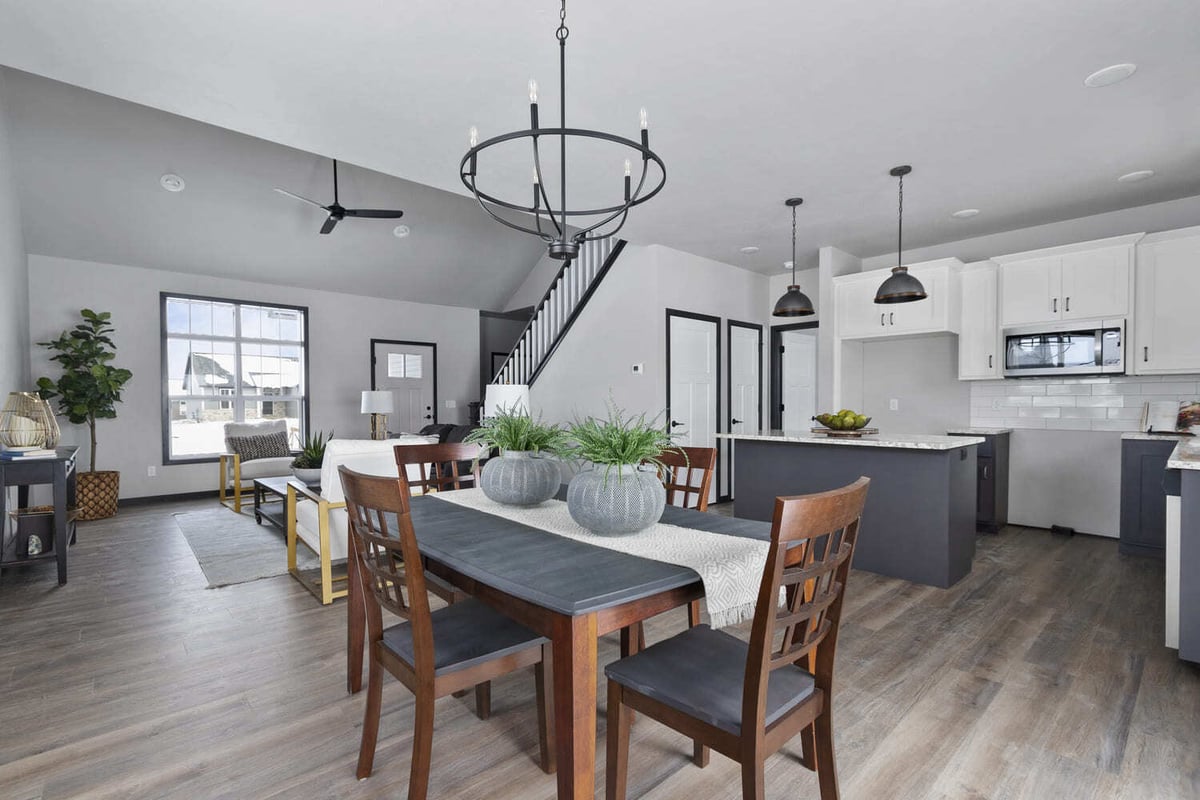 Bright dining area and kitchen with dark wood accents and modern lighting in the Fox Cities
