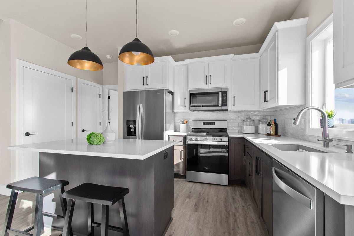 Bright kitchen with stainless appliances and center island by Midwest Design Homes in Greenville, WI