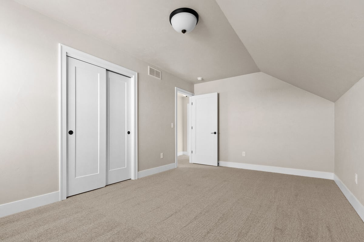 Custom bedroom layout with white trim and beige walls in Kaukauna, WI by Midwest Design Homes