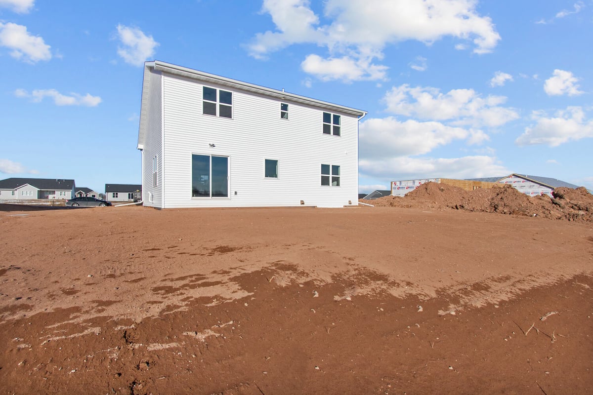 Custom home construction site with white siding in progress by Midwest Design Homes in Kaukauna, WI