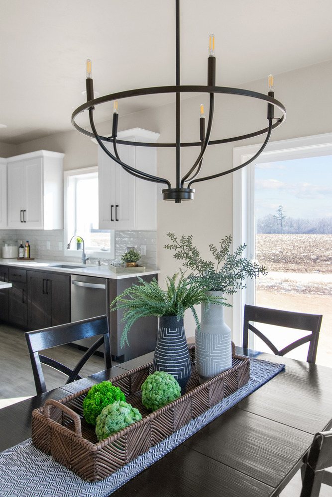 Kitchen and dining room with modern chandelier in custom home by Midwest Design Homes in Fox Cities, WI