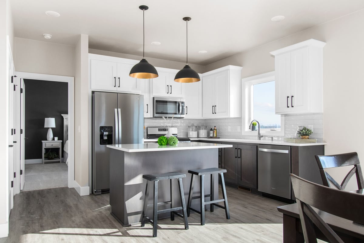 Kitchen with island seating and two-tone cabinetry by Midwest Design Homes in Fremont, WI