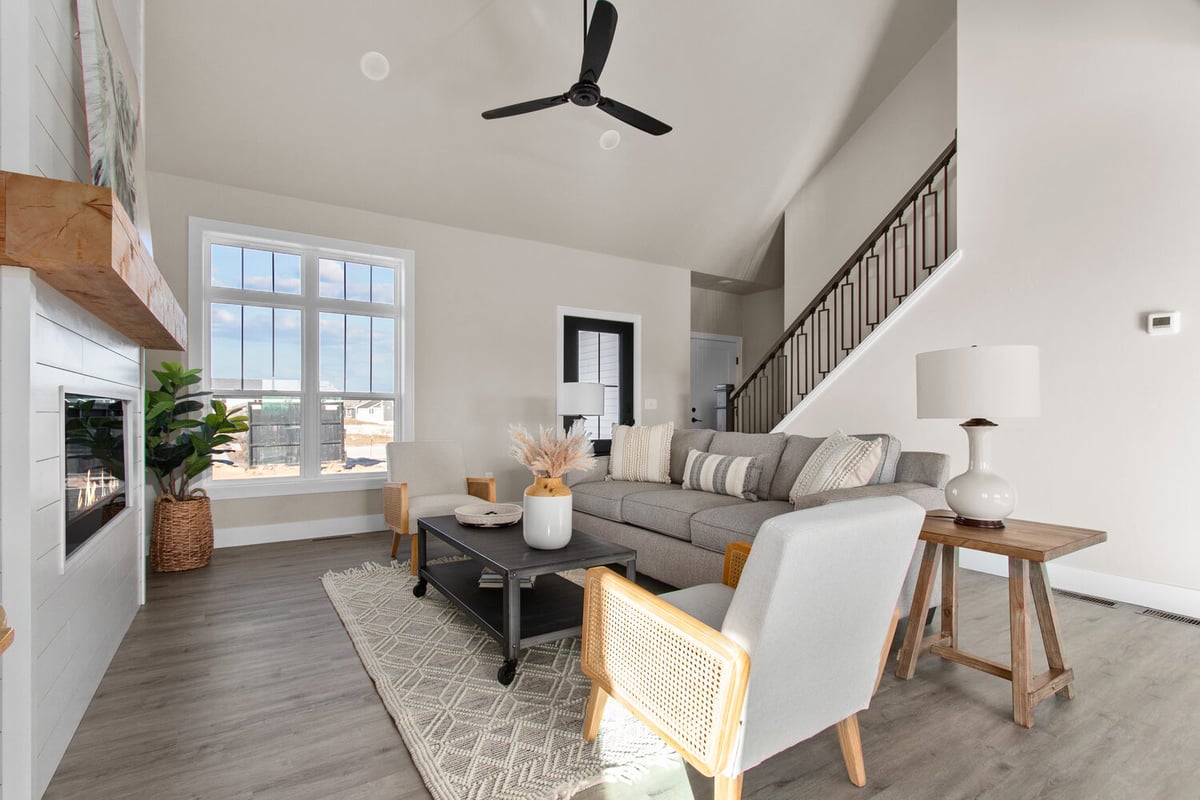 Living room with sectional sofa and large window in a Midwest Design Homes custom home in Greenville, WI