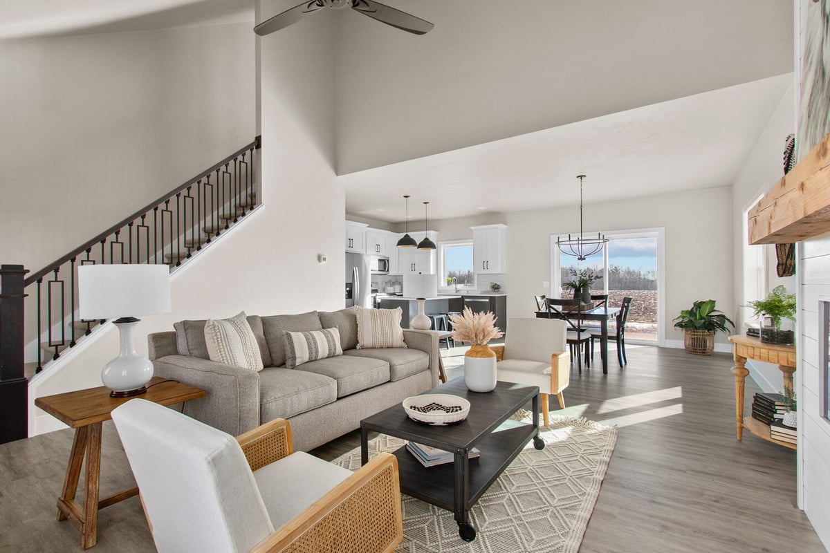 Living space with sofa and view into kitchen and dining areas by Midwest Design Homes in Neenah, WI