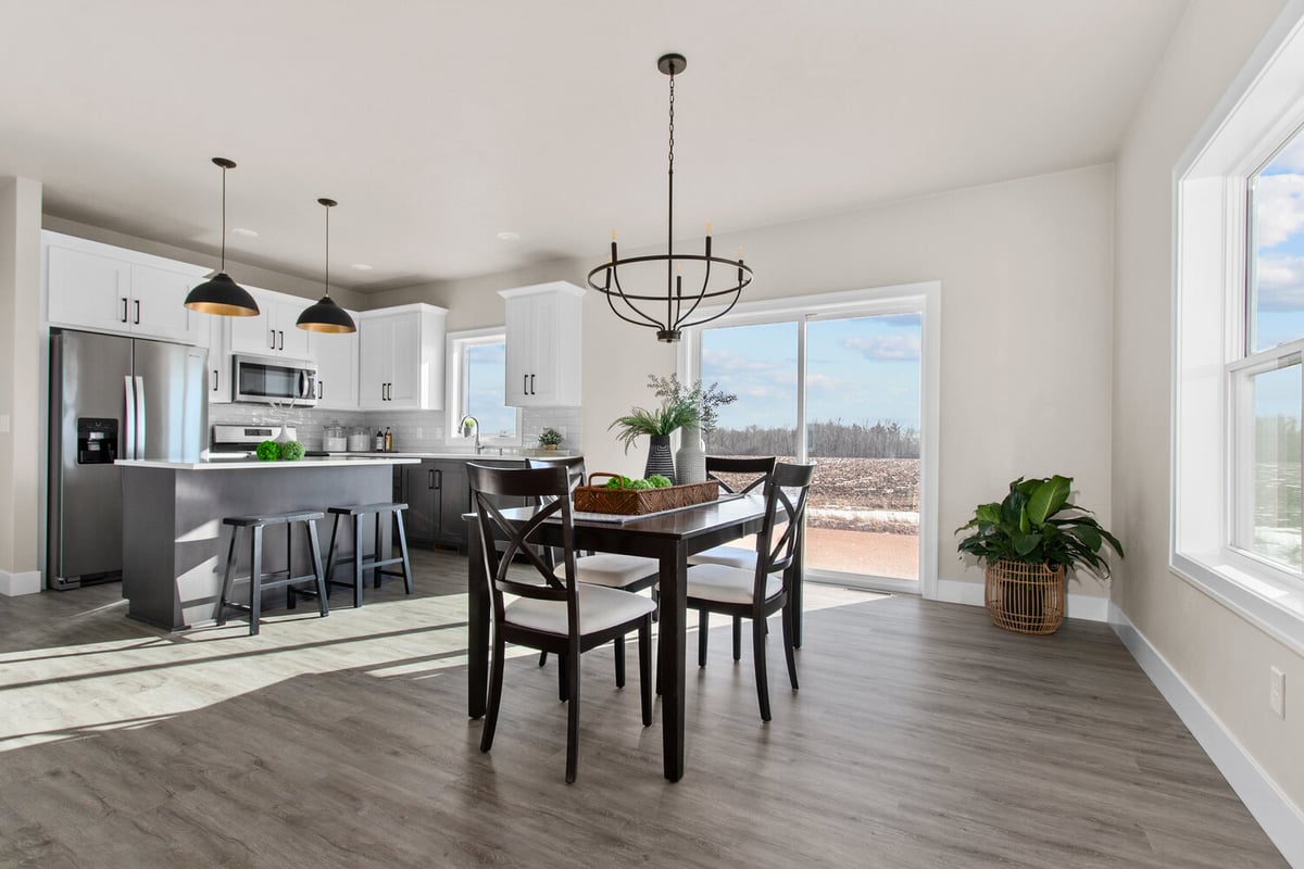 Open dining area with natural light and outdoor views by Midwest Design Homes in Fox Cities, WI