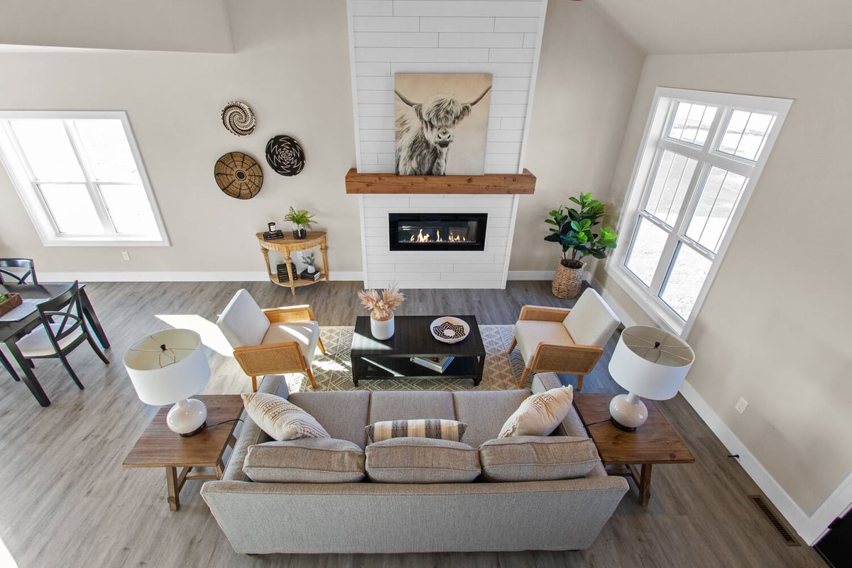 Overhead view of modern living room with fireplace and seating by Midwest Design Homes in Neenah, WI