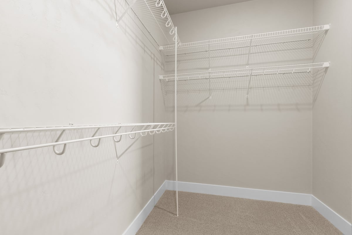 Spacious walk-in closet with white wire shelving by Midwest Design Homes in Green Bay, WI