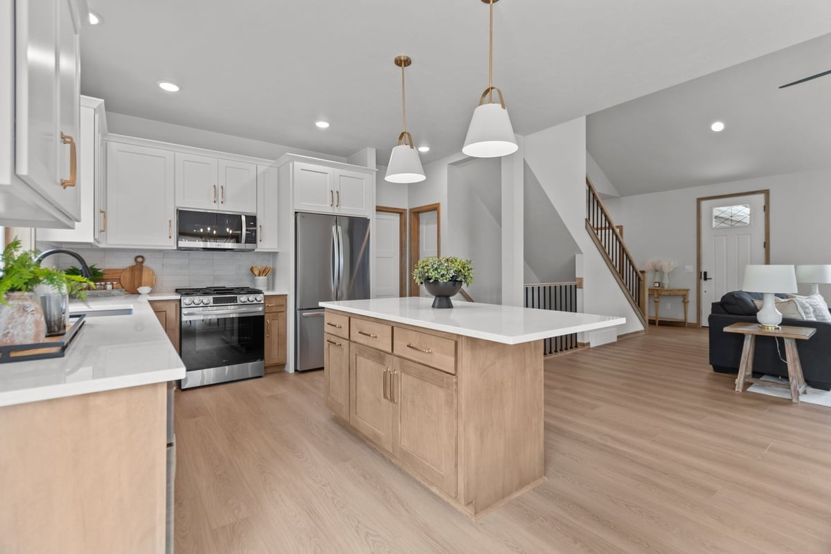 Open kitchen with island and modern finishes in a Lawrence WI custom home by Midwest Design Homes