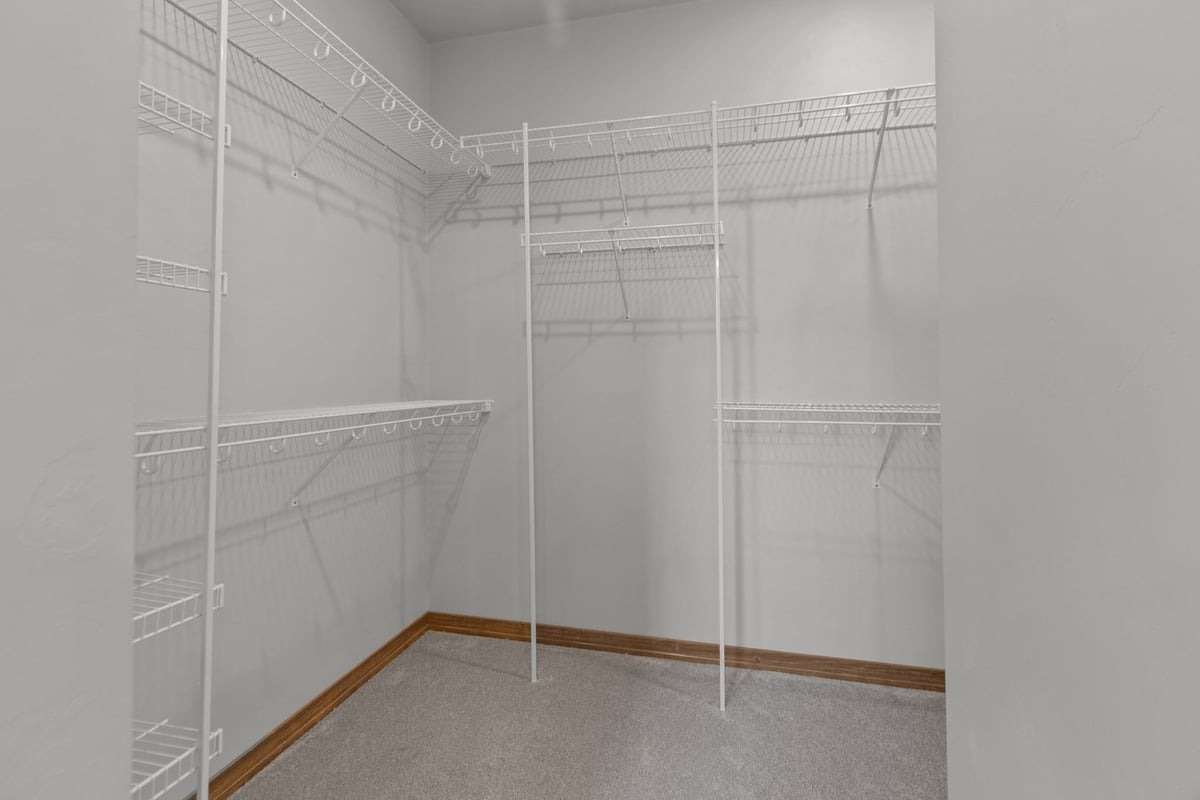 Walk-in closet with white wire shelving in a custom home by Midwest Design Homes in Kaukauna, WI