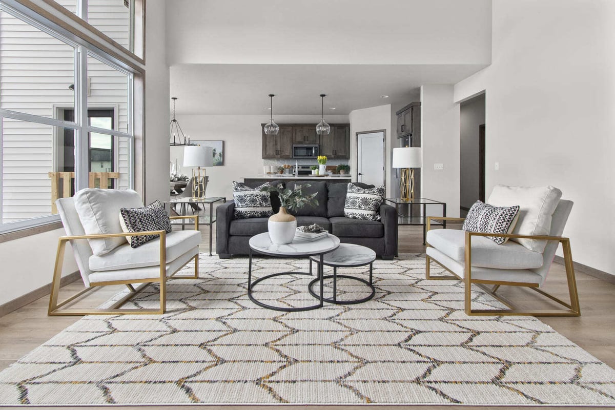 Contemporary open-concept living room and kitchen in the Fox Cities with black and white decor and tall ceilings