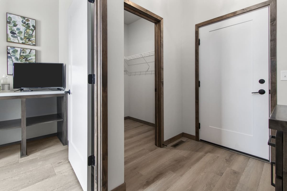 Fox Cities mudroom with laundry folding counter, storage, and adjacent closet