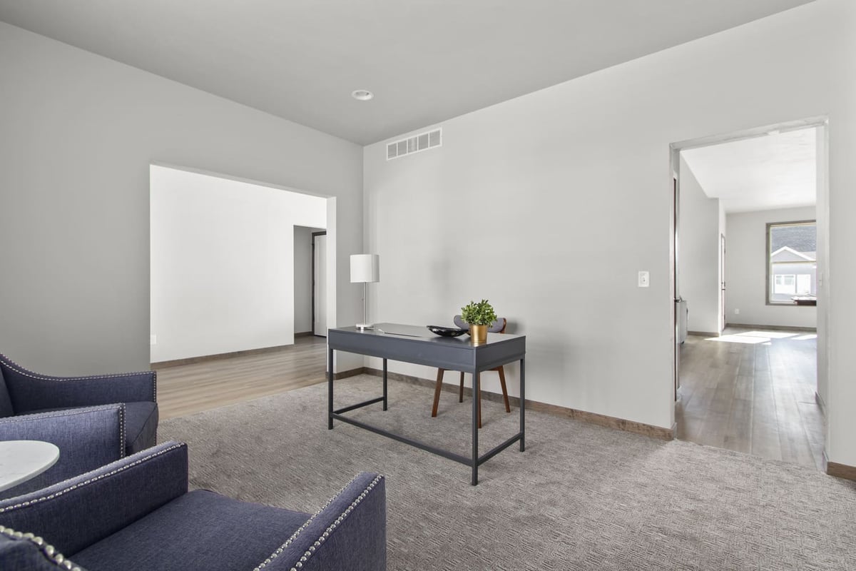 Modern home office in the Fox Cities with a gray desk, two navy chairs, and neutral decor