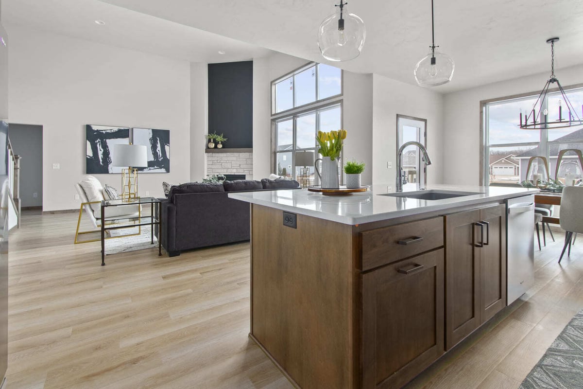 Open-concept Fox Cities kitchen and living area with island, dining space, and modern pendant lights