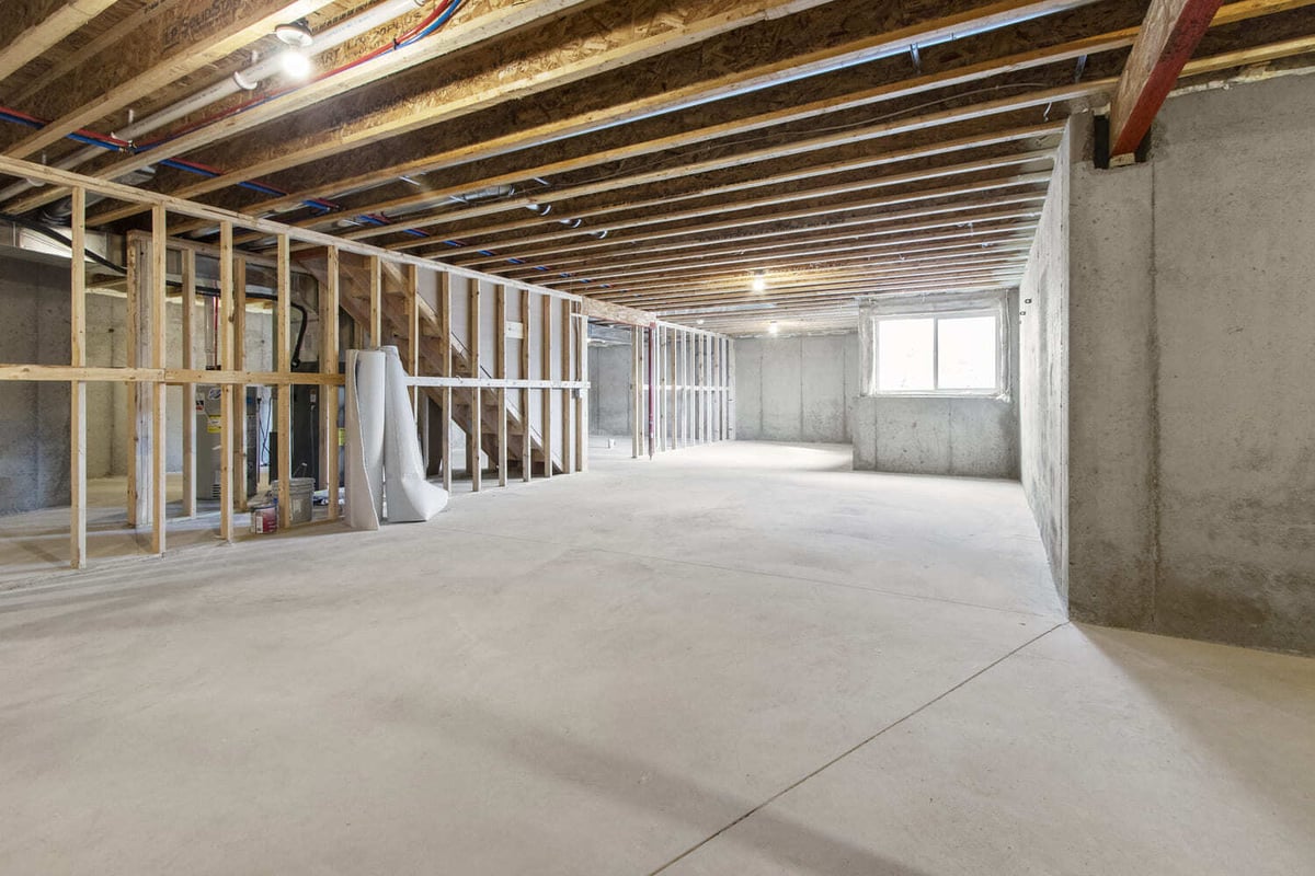 Unfinished basement space in the Fox Cities with exposed framing, concrete floor, and visible HVAC and plumbing