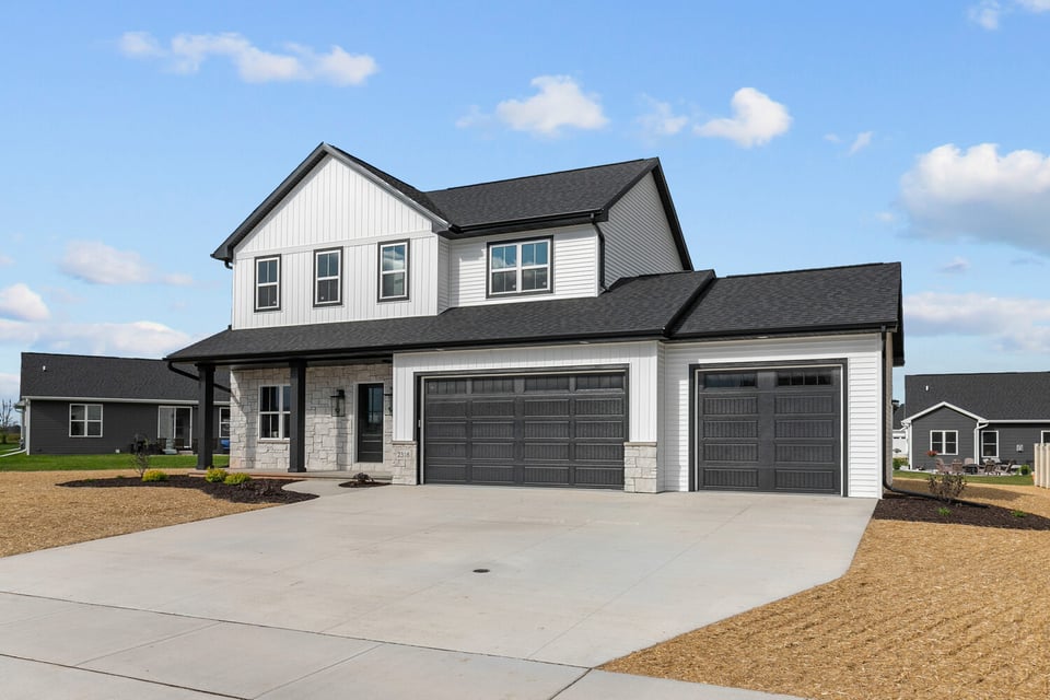 Angled front view of modern farmhouse-style custom home by Midwest Design Homes in Green Bay, WI