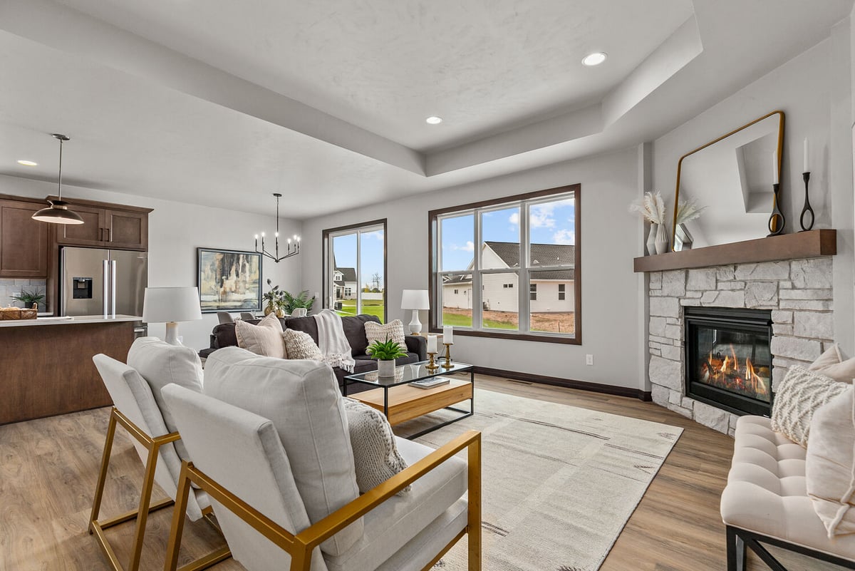 Open living area with fireplace and large windows in a custom home by Midwest Design Homes in Kaukauna, WI
