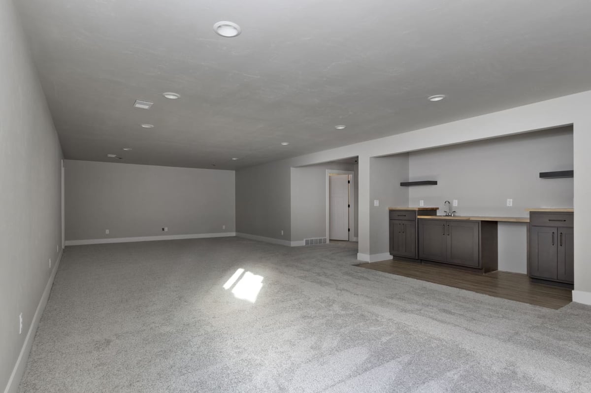 Open finished basement featuring wet bar, recessed lights, and large flexible living space in the Fox Cities