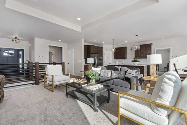 Staged living room with fireplace, large windows, and modern furniture in the Fox Cities