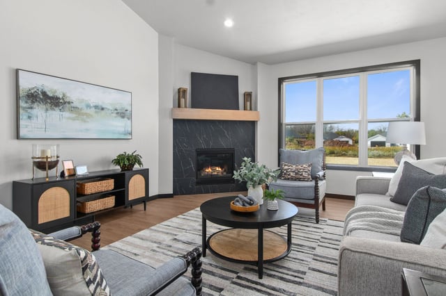 Cozy living room with fireplace and black decor in Fremont, WI custom home by Midwest Design Homes