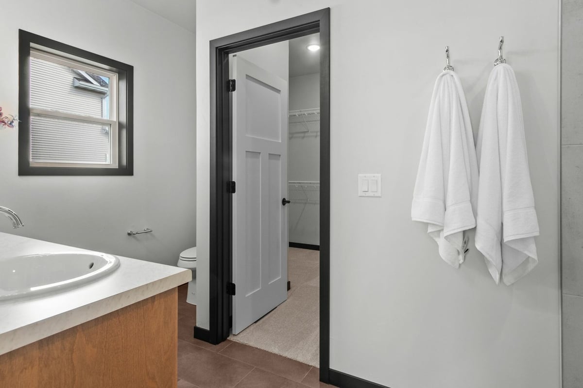 Bathroom with vanity and walk-in closet entry by Midwest Design Homes in Appleton, WI