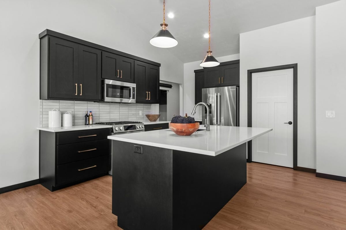 Custom kitchen with black cabinets and white island by Midwest Design Homes in Kaukauna, WI