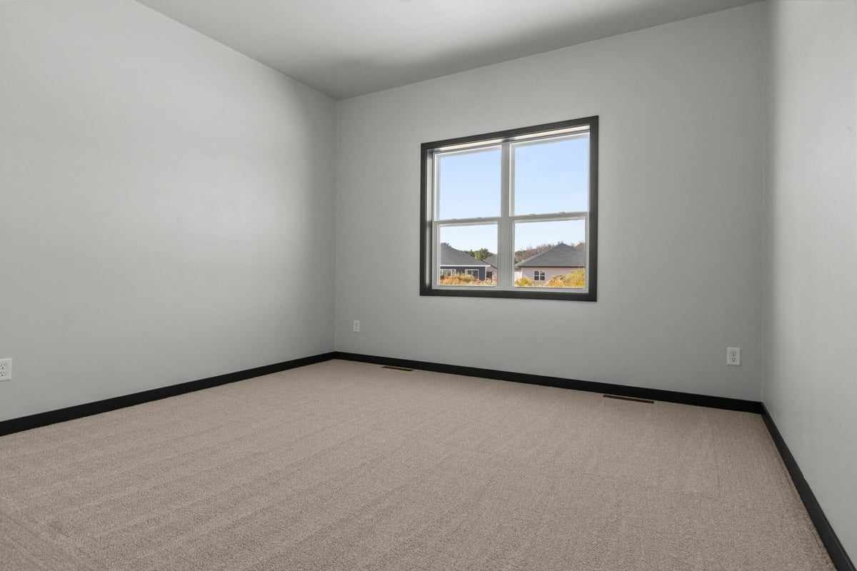 Custom-built bedroom with large window designed by Midwest Design Homes in De Pere, WI